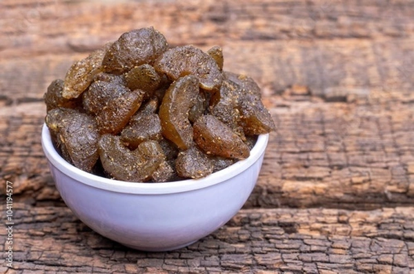 Obraz Amla Candy or Indian Gooseberry Candy in a White Bowl Isolated on Wooden Background with Copy Space, Also Known as Emblica Myrobalan or Phyllanthus Emblica