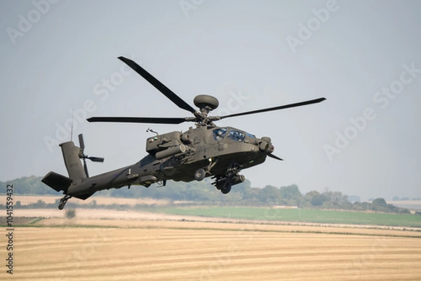 Fototapeta close-up side profile of British army Boeing Apache Longbow Attack helicopter gunship ZM733 AH64E AH-64E ArmyAirCorp in low level banking flight