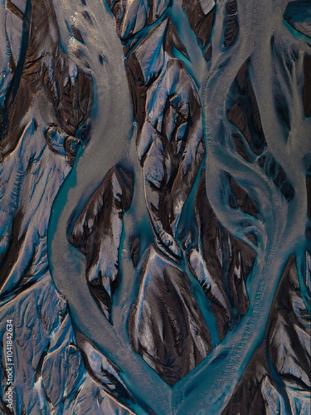 Fototapeta View from above, stunning patterns created in the volcanic sands of Iceland. As glaciers melt the water flows as rivers out to sea. Natural pattern, background, wallpaper.