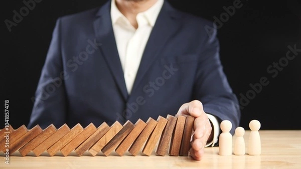 Fototapeta Risk, Business Risk Management, Economic, Financial Crisis Concept. Business man stop wooden block domino effect to safe, protect family, home from economic financial crisis. Concept Risk, Insurance.
