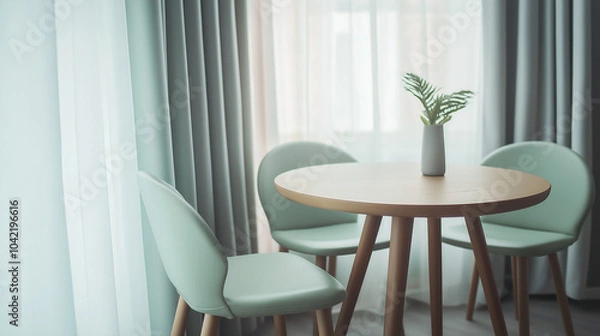 Fototapeta Two mint color chairs at round wooden dining table against window dressed with grey and white curtains. Scandinavian interior design of modern dining room