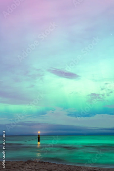 Fototapeta aurora borealis, northern lights above baltic sea in poland, stegna, october 2024