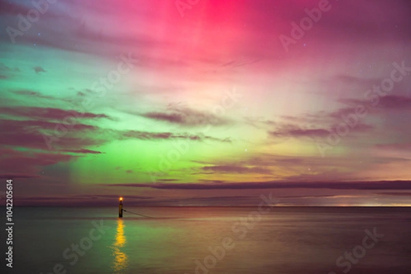 Fototapeta aurora borealis, northern lights above baltic sea in poland, stegna, october 2024
