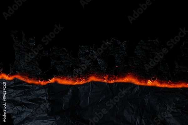 Fototapeta burning paper, glowing edge of paper on a black background