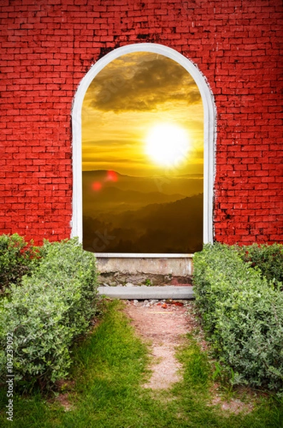 Fototapeta Red brick gate sunset on the mountain