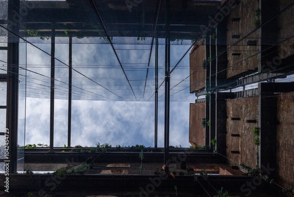 Obraz A view on the sky through the building