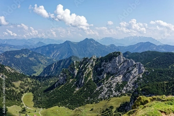 Fototapeta Panoramic view of lush green mountains under clear sky.
