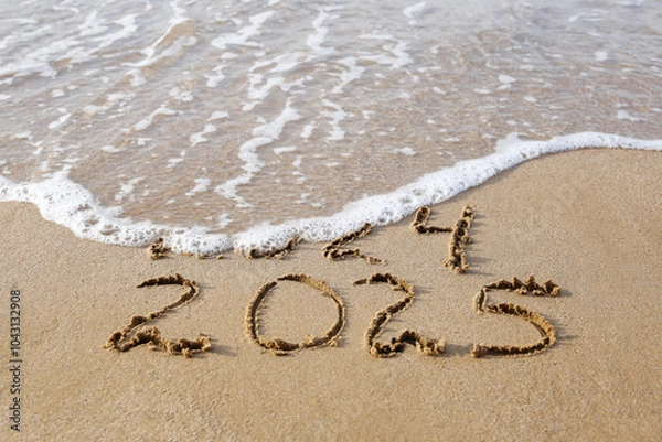 Fototapeta 2024, 2025 years written on sandy beach sea. Wave washes away 2024. Happy New Year!