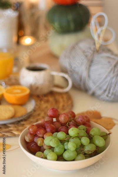 Obraz Pumpkins, various food and drinks, fall decorations, books and candles on the table. Fall hygge at home. Selective focus.