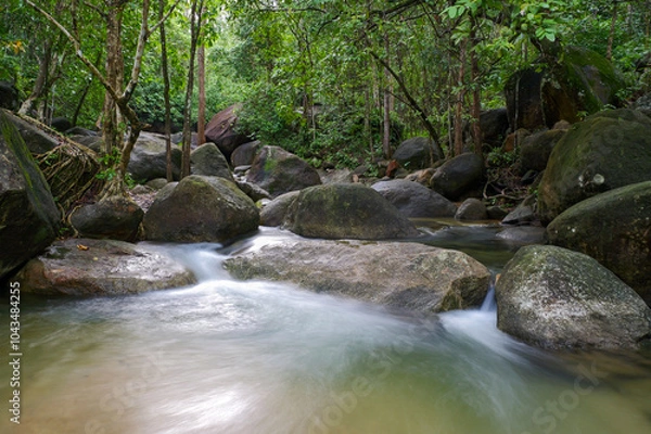 Obraz A stunning waterfall hidden deep in a lush, green forest. , surrounded by towering trees and rich foliage, creating a serene and mystical atmosphere