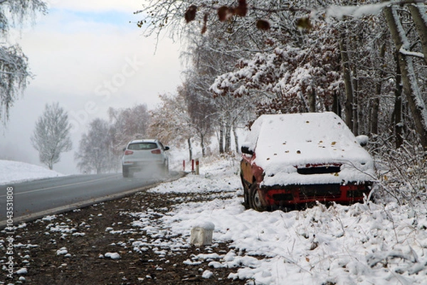 Fototapeta Abandoned car standing by the road. Maybe after the traffic accident or failure. Symbolises also the dangerous conditions in winter with ice, snow and snatch.