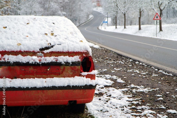Fototapeta Abandoned car standing by the road. Maybe after the traffic accident or failure. Symbolises also the dangerous conditions in winter with ice, snow and snatch.