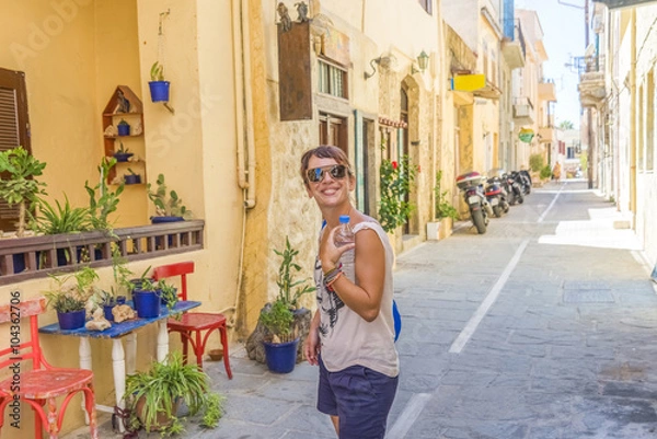 Fototapeta Young pretty girl enjoying the traditional architecture of Crete