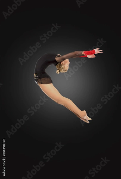 Obraz Professional gymnast  jumping in studio