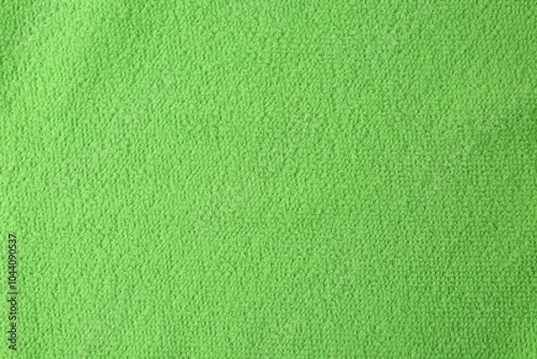 Fototapeta Clean green microfiber cloth as background, top view