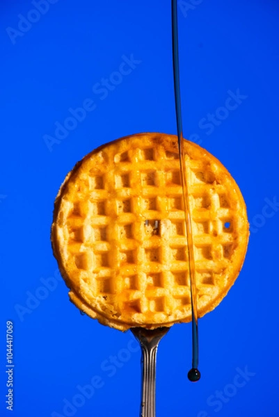 Fototapeta Waffle on Fork with Syrup Dripping Down