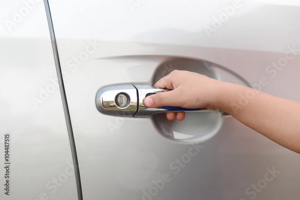 Fototapeta Hand boy pushing button of car handle to open car