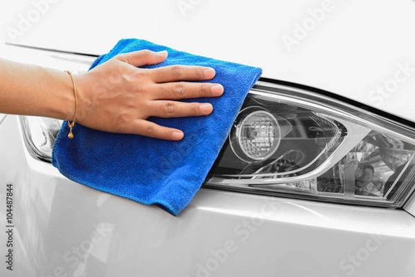 Obraz Hand with microfiber cloth cleaning car