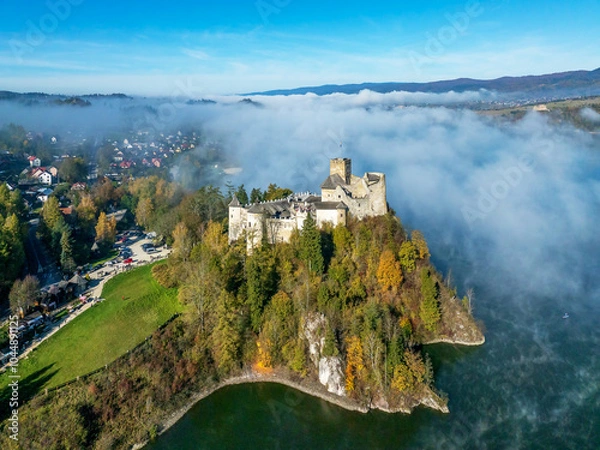 Fototapeta Medieval Castle in Niedzica, Poland, in fall with fog. Aerial view