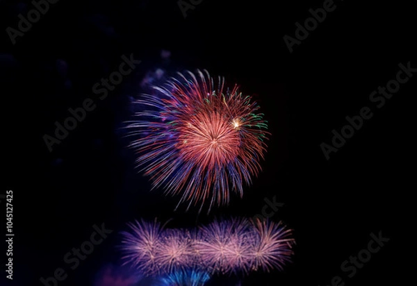 Fototapeta A vibrant burst of fireworks against a dark sky.