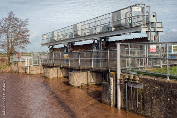 Fototapeta Flood Gates On Road Bridge. Swollen River In Flooded Area