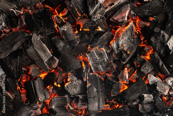 Obraz Hot coals with vibrant red and orange hues, emitting intense heat. Glowing pieces surrounded by dark ash, creating a rustic atmosphere