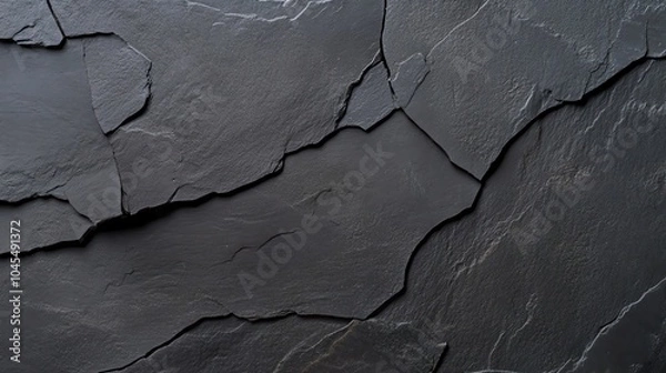 Fototapeta Close-up of dark cracked slate texture, showcasing rugged natural detail and abstract beauty, perfect for backgrounds and design projects.