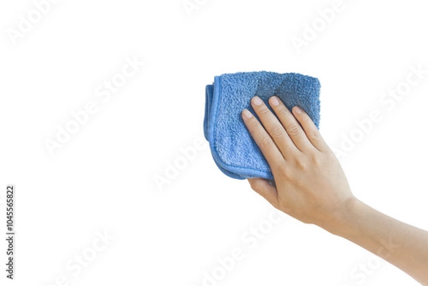 Obraz A hand holding a blue microfiber cleaning cloth against a white background. copy space