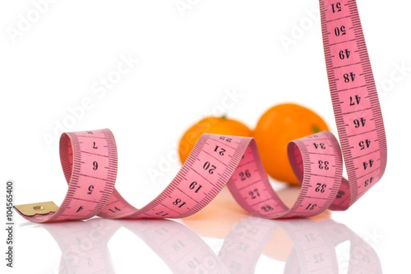 Obraz fruits and measuring tape on a white background to symbolize diet