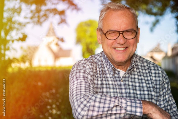 Fototapeta Portrait of an attractive senior in countryside