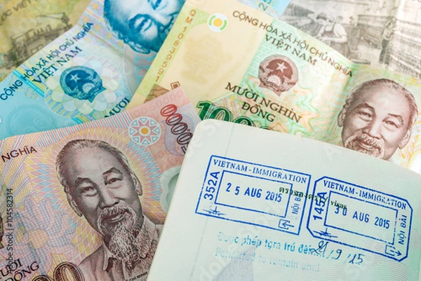 Obraz Visa passport stamp from vietnam and Vietnamese money (Dong)