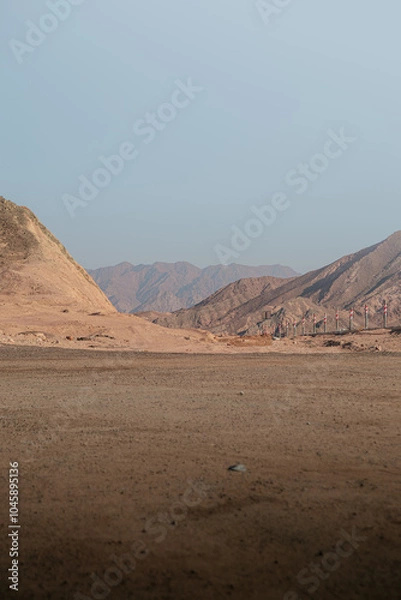 Obraz mountain range landscape. The mountains are characterized by sharp rocky outcroppings and steep slopes covered with rocks and little vegetation. The colors of the mountains range from dark brown to li