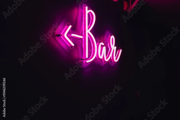 Fototapeta glowing pink neon Bar sign with arrow on a black background
