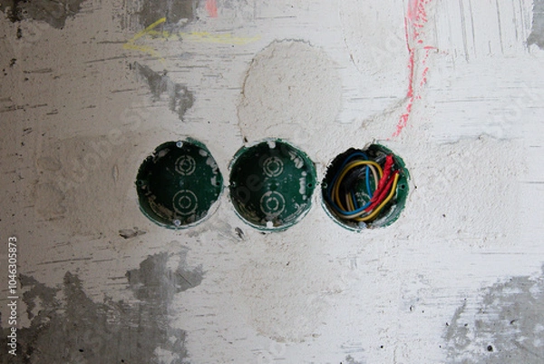 Obraz Green three wall boxes in a concrete wall. Installation of an electrical outlet in an apartment