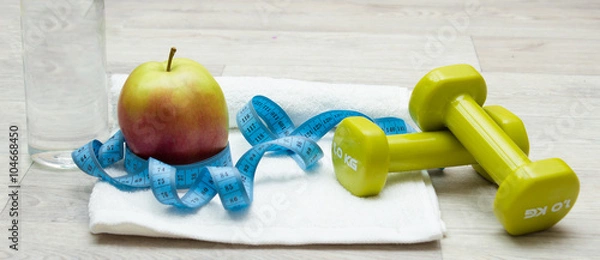 Obraz Tasty apple, measure tape and weights on towel