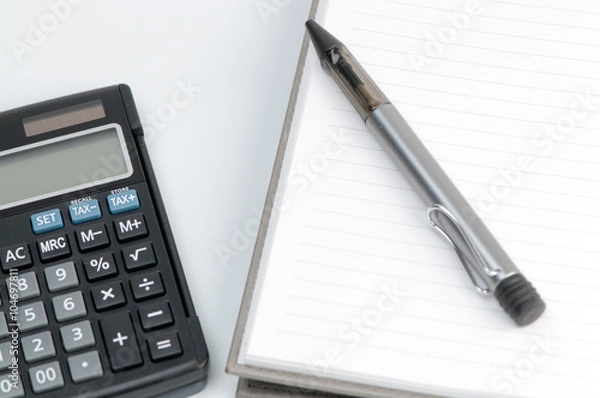 Fototapeta calculator and blank notebook