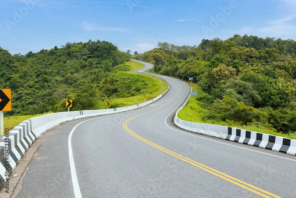 Fototapeta Popular view point of double s-curve road up to the hill with green tree and sky, called curve number 3 at Nan province, Northern of Thailand