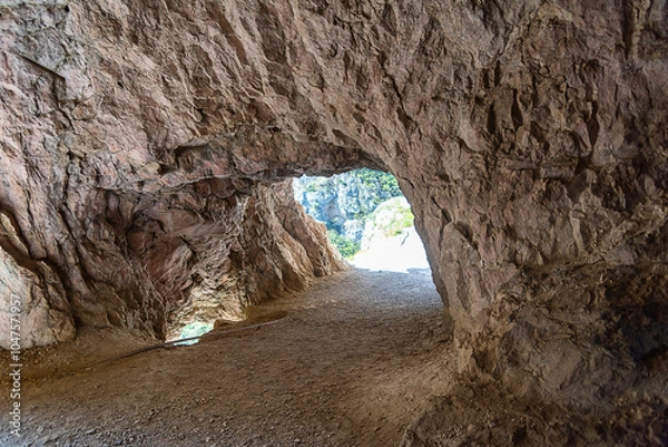 Fototapeta a through road passing through the mountain, a passage in the rock
