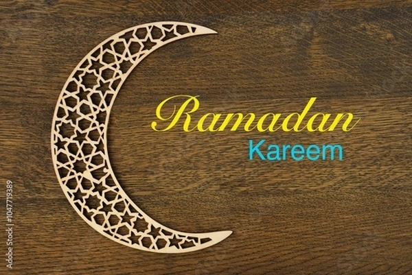 Obraz Islamic pattern crescent moon  with "  Ramadan Kareem " text on brown wooden background . 