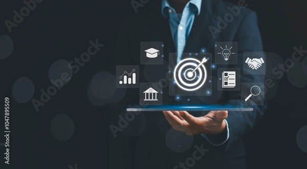 Fototapeta Goal and target concept, businessman showing dartboard and arrow on hand to set business goals, marketing solutions, strategy or data analysis to achieve best business results