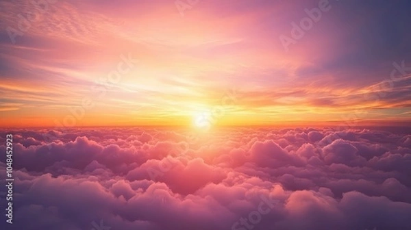 Fototapeta A vibrant sunset sky from an airplane window, with shades of orange, pink, and purple blending across the horizon above the clouds