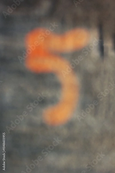 Fototapeta A dreamy view of the number five painted on a sidewalk.