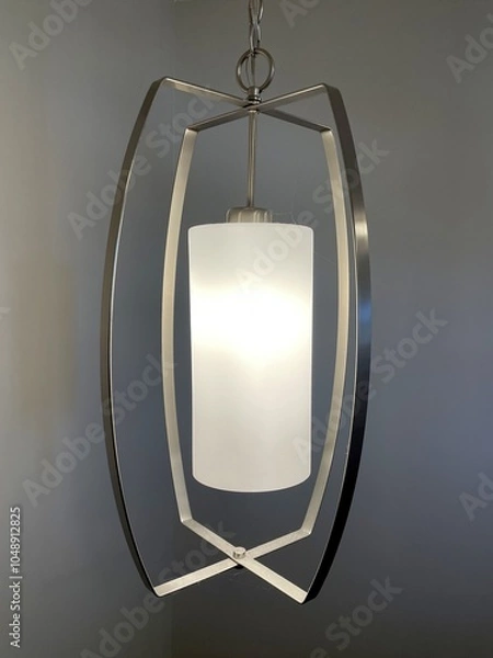 Obraz A modern looking hanging ceiling light in nickel finish.