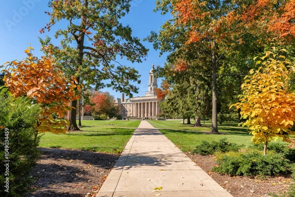 Fototapeta Autumn alley in the campus of Pennsylvania State University in autumn sunny day, State College, Pennsylvania.