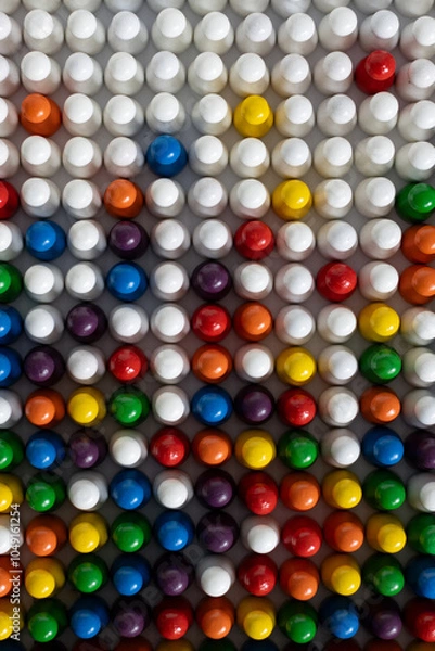 Fototapeta Playful Conceptss: Colorful gamefigurines in a pattern symbolizing increasing diversity
