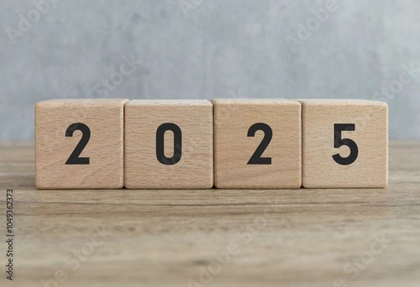 Fototapeta Wooden Blocks Displaying the Year 2025 on Wooden Surface with Gray Background