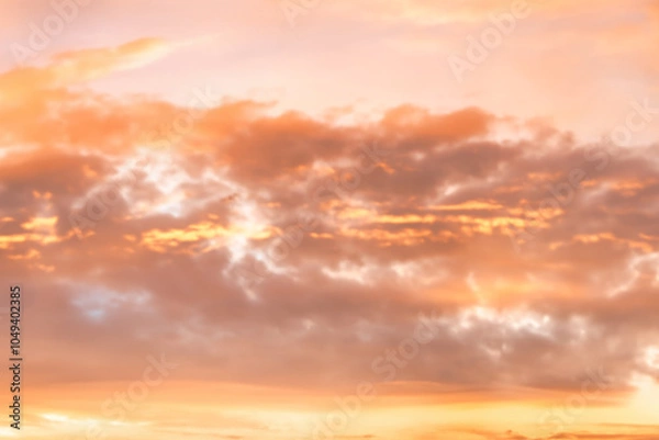Fototapeta A beautiful sky tinted by the sun leaving vibrant shades of gold, pink, blue and multicolored. Clouds in the twilight evening and morning sky. Cloudy sky background in the evening, and during the day.
