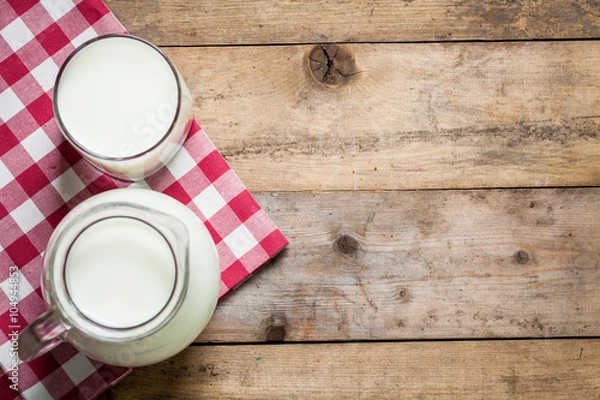 Obraz Fresh Milk on Glasses Bottle, Dairy Produce Concept of Breakfast on Wood Table Background, Country Rustic Still Life Style, Vintage Tone, Top view. Space for text.