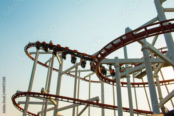 Obraz Theme Park Rollercoaster against blue sky .