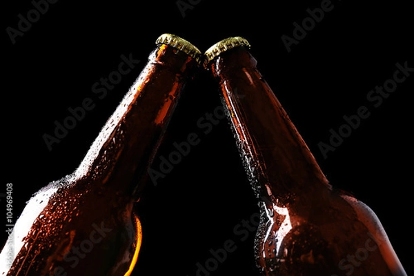 Fototapeta Two glass bottles of beer on black background